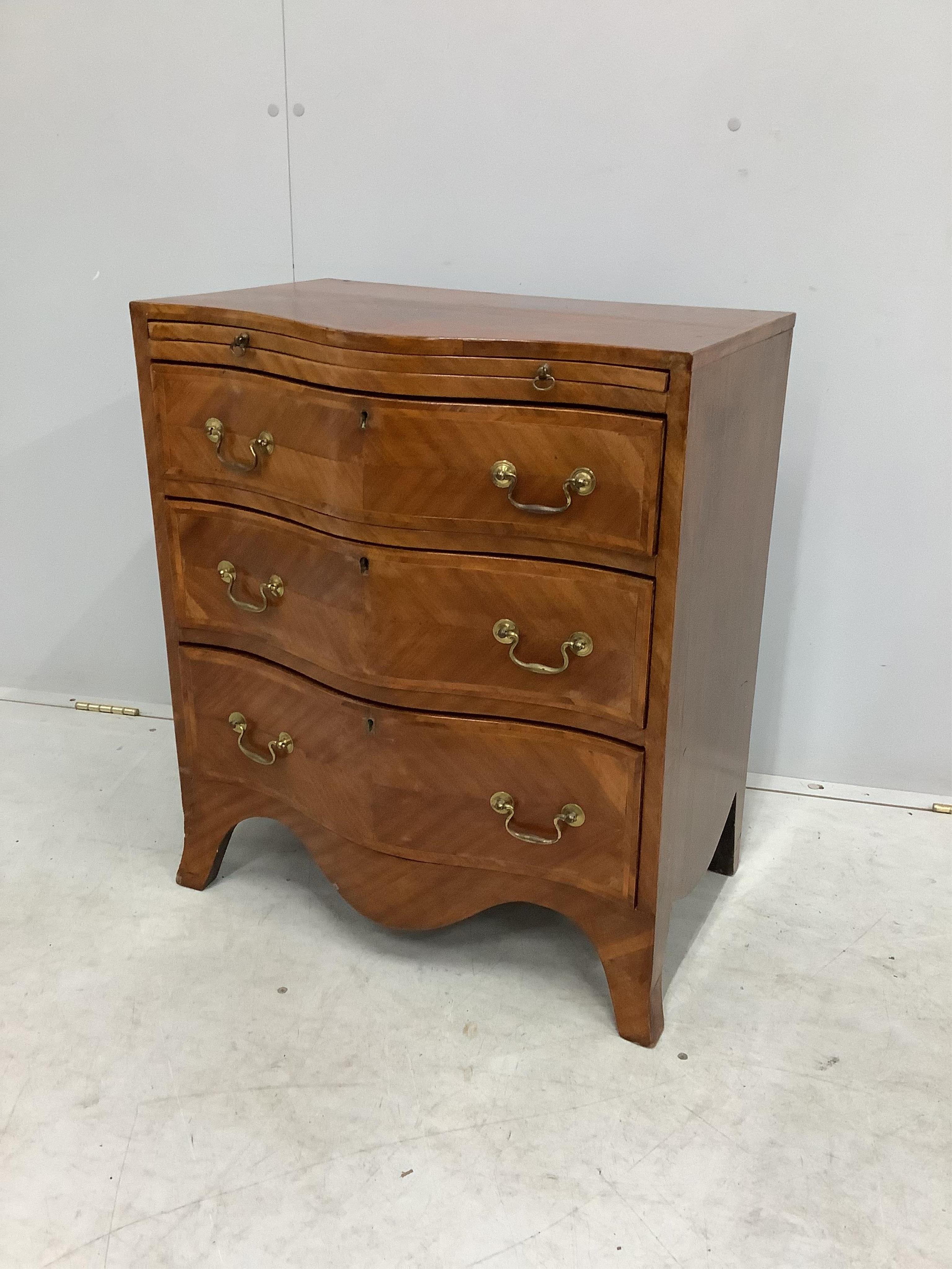 A small reproduction mahogany serpentine chest, with slide, width 60cm, depth 39cm, height 71cm. Condition - fair